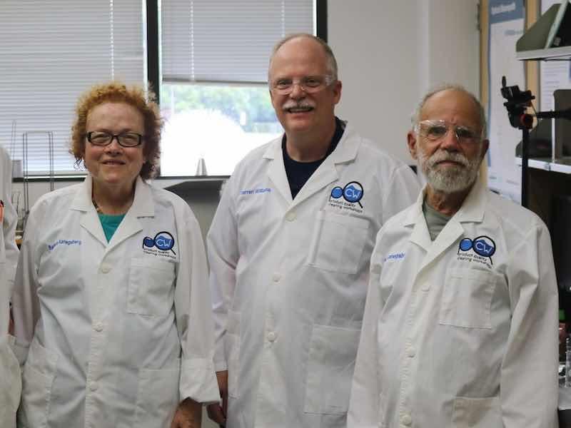 3 people standing in a lab