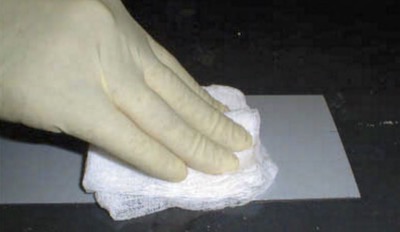 hand rubbing solvent on a surface
