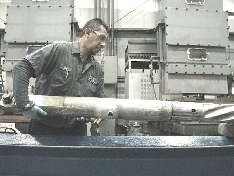 man holding large drill